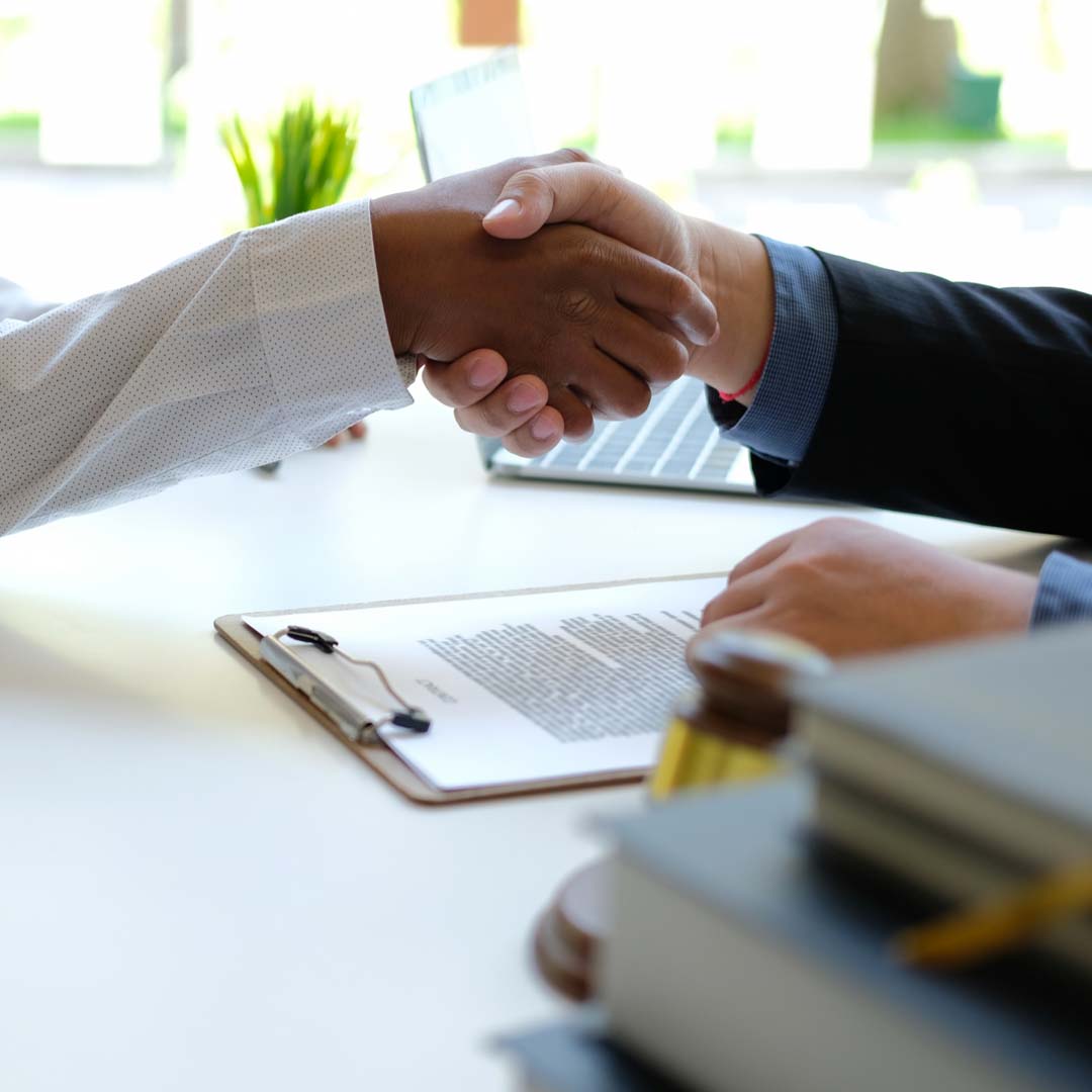 A realtor shaking hands with clients