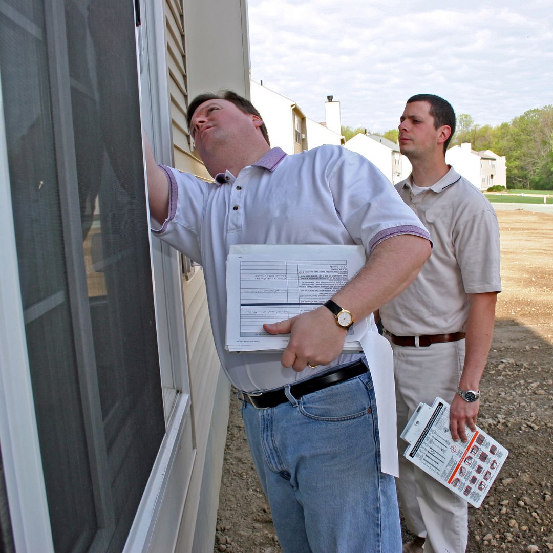 two inspectors looking at windows