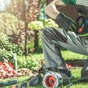 man fixing sprinkler