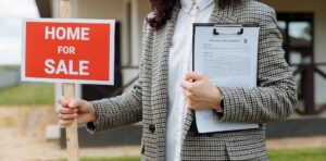 Realtor and a "For Sale" sign.